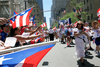 Marchers wave Puerto Rican flags.
