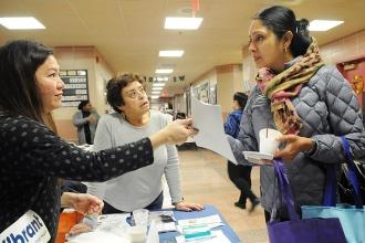 Suchrita Kamath, a Queens parent, gets information from the Queens Family Resour