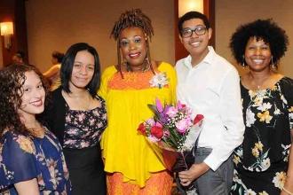 Joyce Parker (center) celebrates her Si Beagle Award with smiles and flowers fro