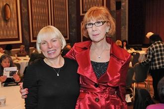 Gerri Herskowitz (right) welcomes new retiree Danielle Lehtinen to the luncheon.