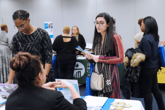 Women stops at information table