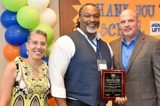 Counselor Stevie Burell of Bedford Academy HS in Brooklyn shows off his plaque as he poses with School Counselor Chapter Leader Rosemary Thompson and Mulgrew.