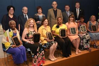 The award recipients and their presenters take a group shot on stage.
