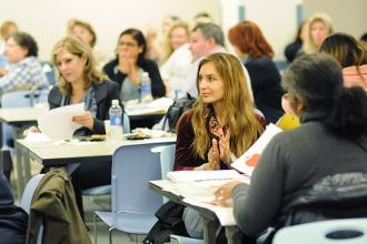 Besa Gashi, a school secretary at PS 89 in the Bronx, applauds one of the speake
