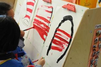 Students show their love for Dr. Seuss’ stories by painting the signature hat wo