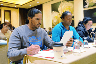 Parent Mark Garcia participates in a workshop on ELA writing standards.