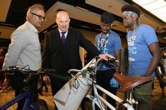 Mulgrew with Pathways to Graduation HS teacher Ariff Hajee (left) and students i