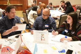  Larry Sachs (left) of PS 57 in the Bronx shares an idea with Jason Feliciano of