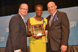 Lorna Baptiste flanked by Arthur Pepper and President Mulgrew.
