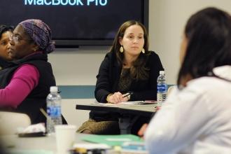 Nicole Marrero, a universal literacy reading coach, listens to one of the speake