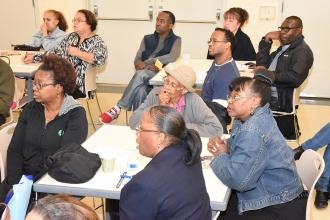 Parents and grandparents listen during a workshop