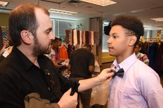 Teacher A.J. Gjikola makes the necessary adjustments for student Ismael Nunez of