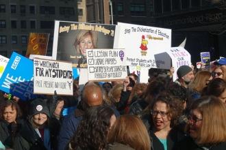 Education-themed signs at the New York City march.
