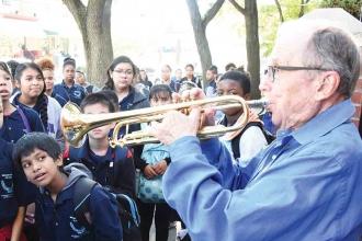 Docent Ed Polcer, a cornet player who has performed at the White House and the r