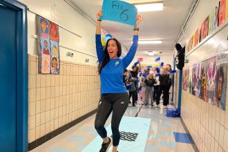 PS 75M members take part in a mini pep rally down a runway during the UFT's Fix Tier 6 Day of Action