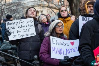 Sam Multer, a teacher at PS 282 in Park Slope, Brooklyn, and Leni Abraham, a physical  therapist who serves multiple schools, carry signs in solidarity with Minneapolis.