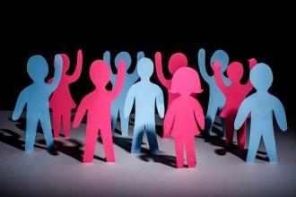 An image of people made of paper with their hands up