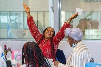 A woman raises her hands in celebration