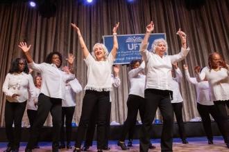 A group of retirees dance on stage 