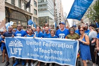 UFT and AFT Leadership take a photo while marching together