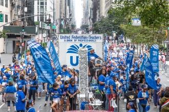 A large crowd of UFT members march in the NYC Labor Parade