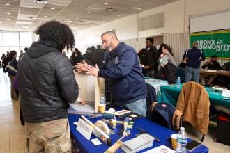 A student gets information at a table during the UFT's Future in Focus fair. 