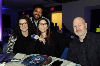 Award-winner Alexandra Rochford (center), a teacher at Manhattan’s HS of Fashion Industries, enjoys the ceremony surrounded by family and colleagues at the UFT CTE Awards on Feb. 12, 2026. 