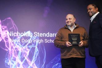 Teacher Nicholas Stendardo, a 23-year veteran of New Dorp HS on Staten Island, is congratulated by Leo Gordon after being honored with the Work-Based Coordinator for Excellence and Innovation Award during the UFT CTE Awards on Feb. 12, 2026. 