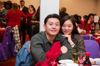 An occupational therapist and her husband smile for a photo at their table during the 2024 UFT Lunar New Year celebration