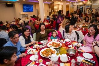 A group of attendees at the 2024 UFT Lunar New Year celebration enjoy a traditional Chinese meal