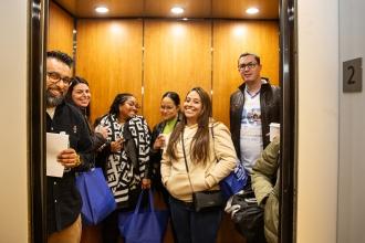 A group of school counselors and UFT staff in the UFT elevator on the second floor.