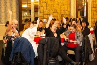 A group of attendees clap for an award winner