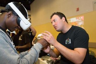 A student is helped with a virtual reality headset 