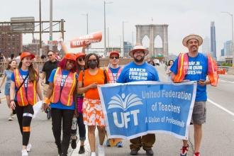 A group of UFT members walk while being close together