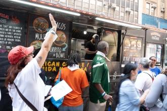 Parade attendees and UFT members line up at a food truck