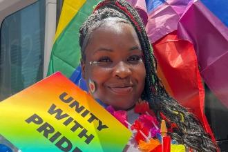 A woman holds up her sign. 