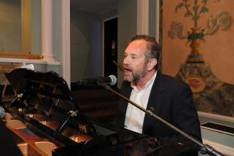 A retiree sings and plays the piano at the 2024 UFT Retired Teachers Chapter Luncheon.