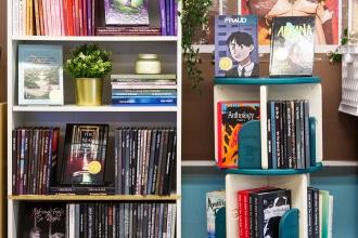 Student novels displayed on bookcase