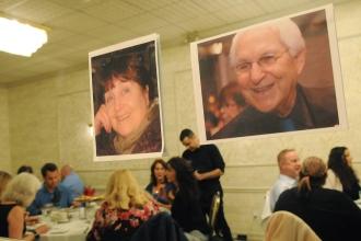Photos of two dinner honorees are displayed on a mirror