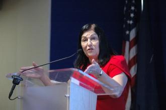 UFT Vice President Anne Goldman speaks at the podium