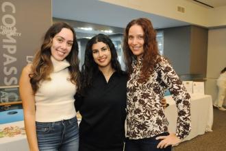 Three psychologists in attendance at the UFT's Psychologist Appreciation Day held at UFT headquarters smile for a group photo. 