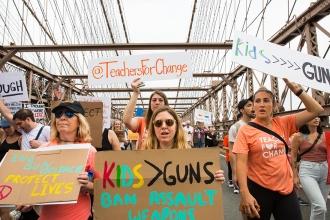 A group marches across the Brooklyn bridge in support of gun control