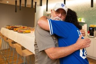 A man and a woman share an embrace in a newly renovated office space.
