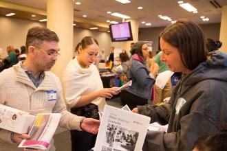 Members look over flyers and information for the event. 