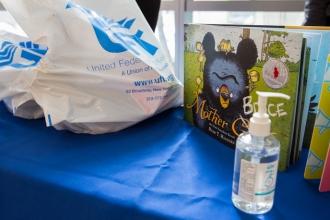 Hand sanitizer, a UFT plastic bag and books on display.