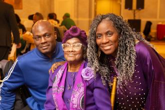 A group of three attendees at the UFT African Heritage Committee Scholarship Dinner Dance pose for a photo. 