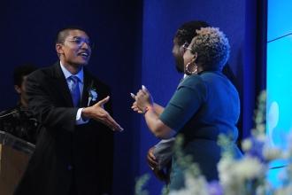 Awardee shakes hand on stage