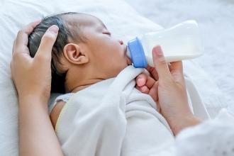 Baby feeding on bottle