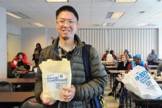 Le Liang, a parent of a student at PS 65 in Cypress Hills, Brooklyn, shows off his UFT swag bag before heading to a workshop at the UFT Brooklyn Parent Conference on Oct. 25, 2025.