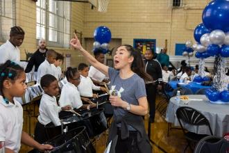 Teacher dances in front of seated students